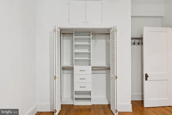 a view of empty room with wooden floor