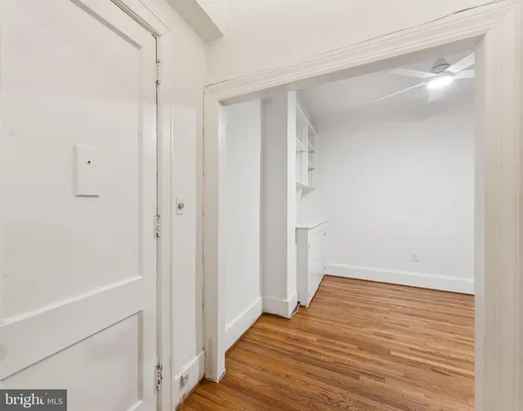 a view of a hallway with wooden floor