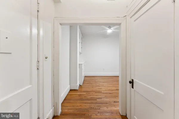 a view of an empty room with wooden floor