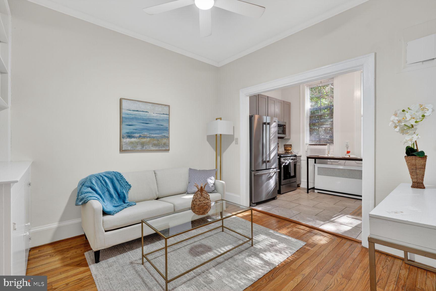 3039 Macomb Street Northwest, Unit 16 Washington, DC 20008 - Photo 4 of 17 a living room with furniture and wooden floor