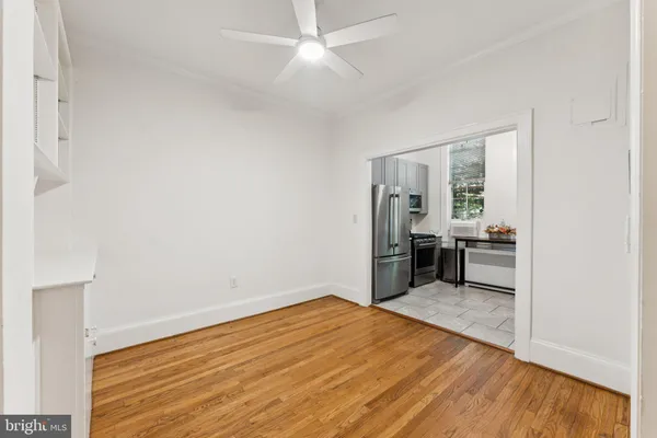 a view of empty room with wooden floor