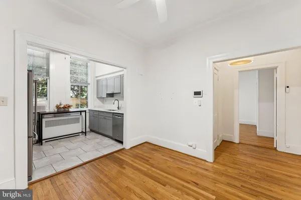a room with wooden floor and a view of bedroom