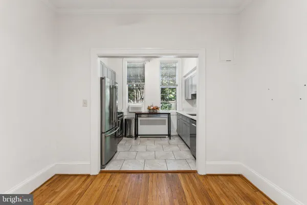 a kitchen with stainless steel appliances granite countertop a sink stove refrigerator and cabinets