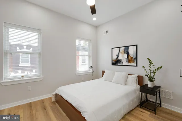 a bedroom with a large bed and a window