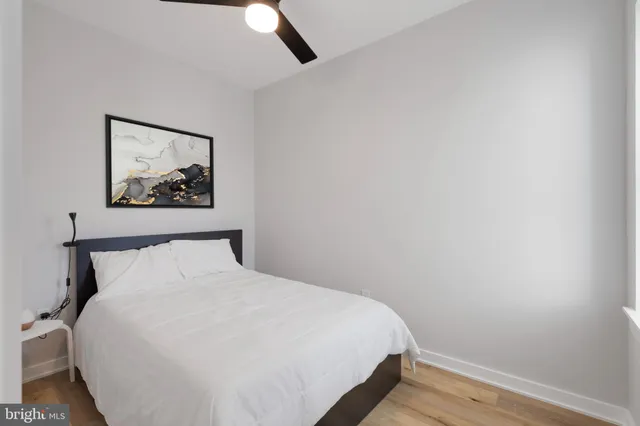 a bedroom with a bed and a painting on the wall