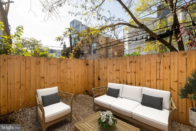a outdoor living room with furniture and a rug