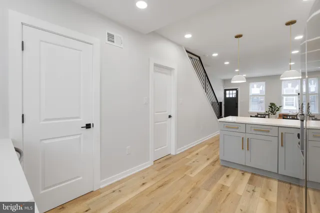 a large white kitchen with a sink