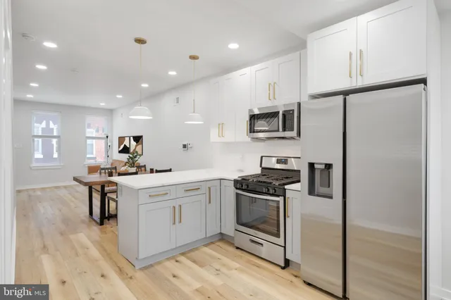 a kitchen with a sink stainless steel appliances and cabinets