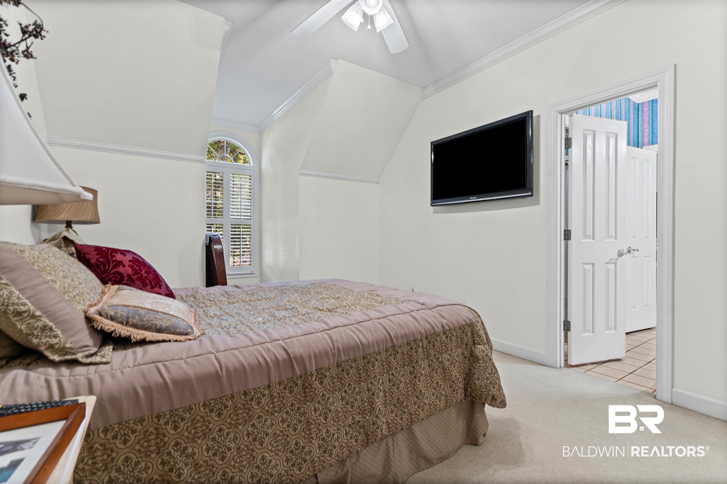 107 Beaver Dam Road Fairhope, AL 36532 - Photo 26 of 45 Bedroom featuring lofted ceiling, light colored carpet, ornamental molding, and ceiling fan