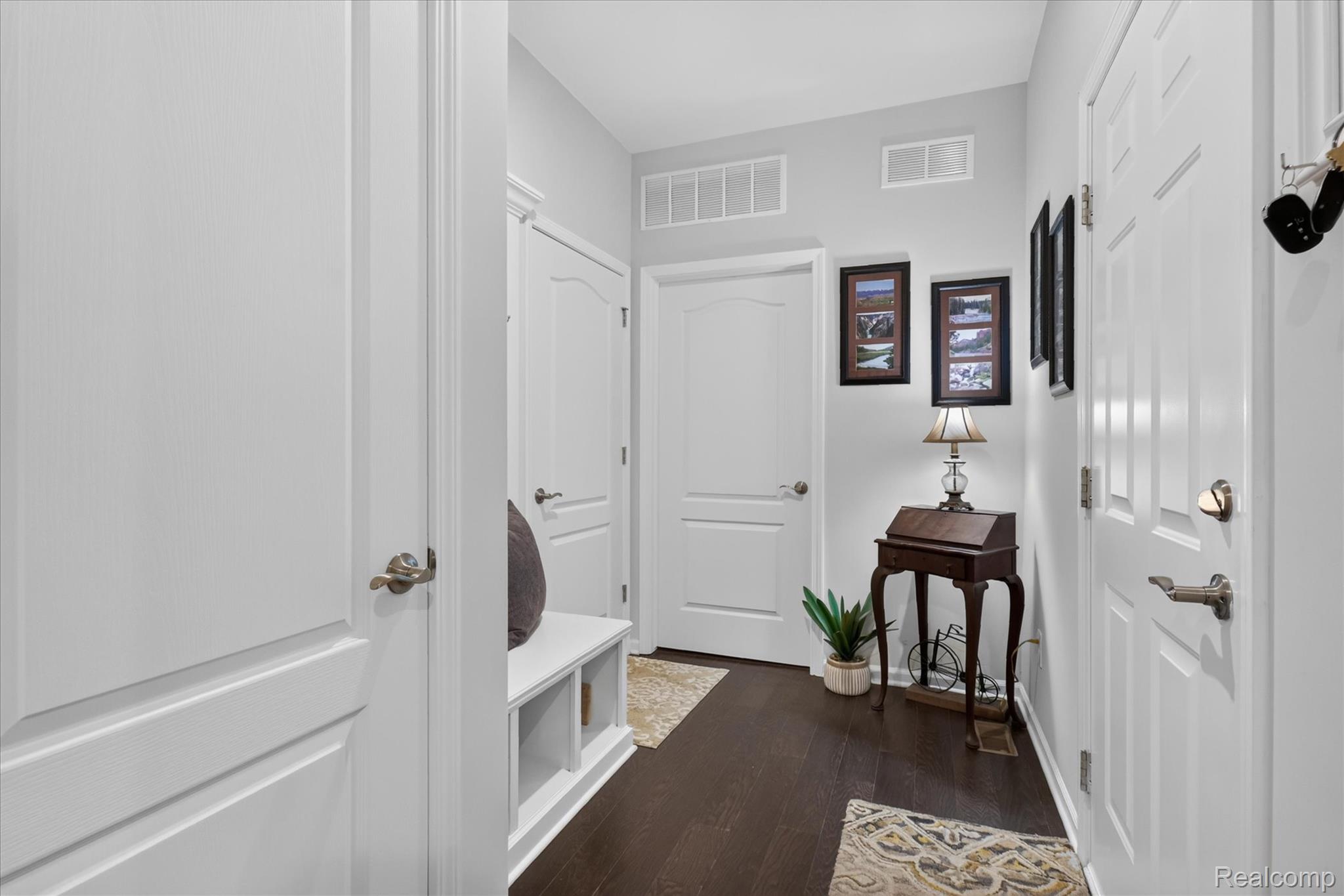 4795 Bingham Road Canton, MI 48188 - Photo 34 of 50 Dark wood-finish flooring, white panel doors, and a built-in storage bench