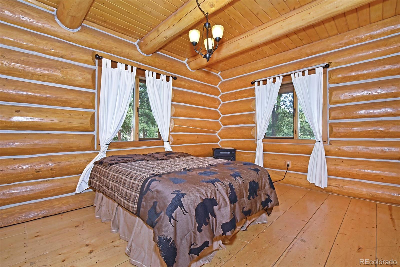 79 Buggy Whip Road Bailey, CO 80421 - Photo 18 of 39 a bedroom with a bed and a window