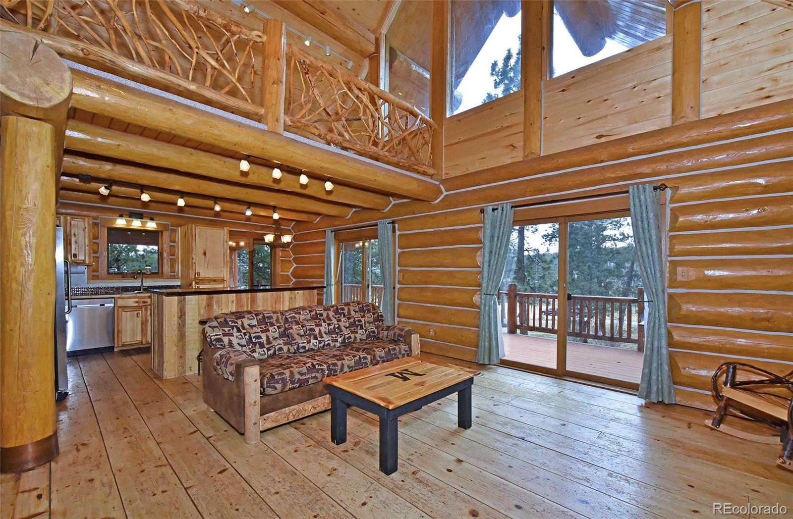 79 Buggy Whip Road Bailey, CO 80421 - Photo 4 of 39 a outdoor space with lots of wooden furniture and windows