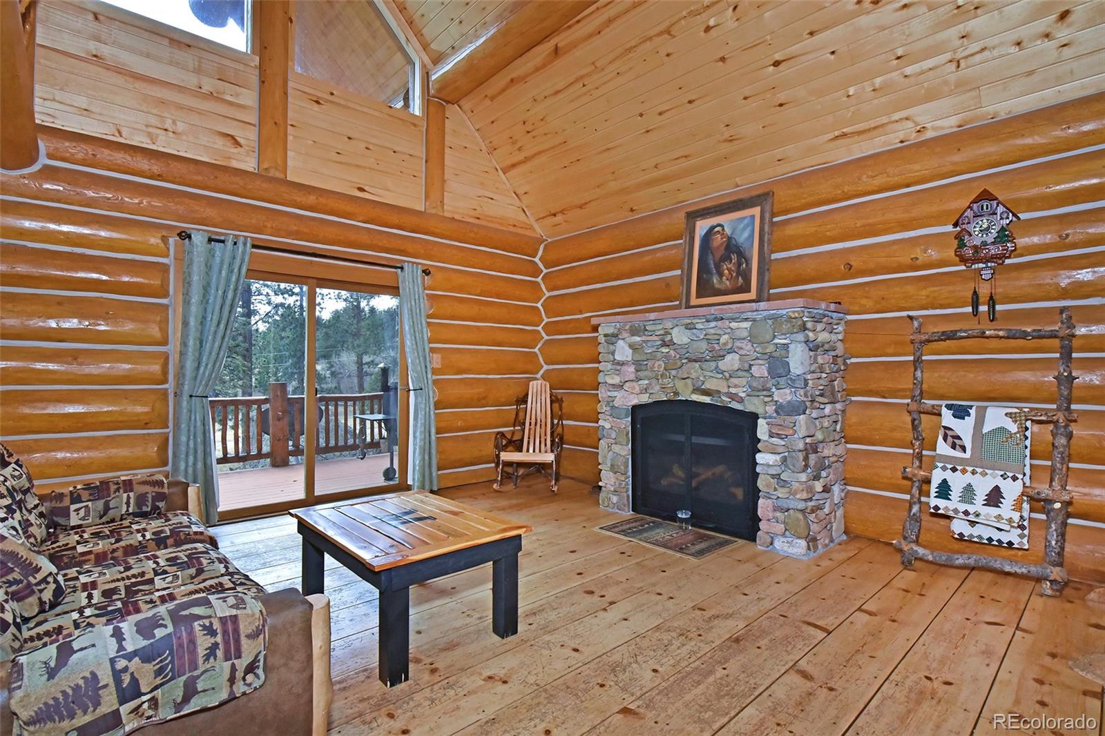 79 Buggy Whip Road Bailey, CO 80421 - Photo 7 of 39 a living room with furniture a window and a fireplace
