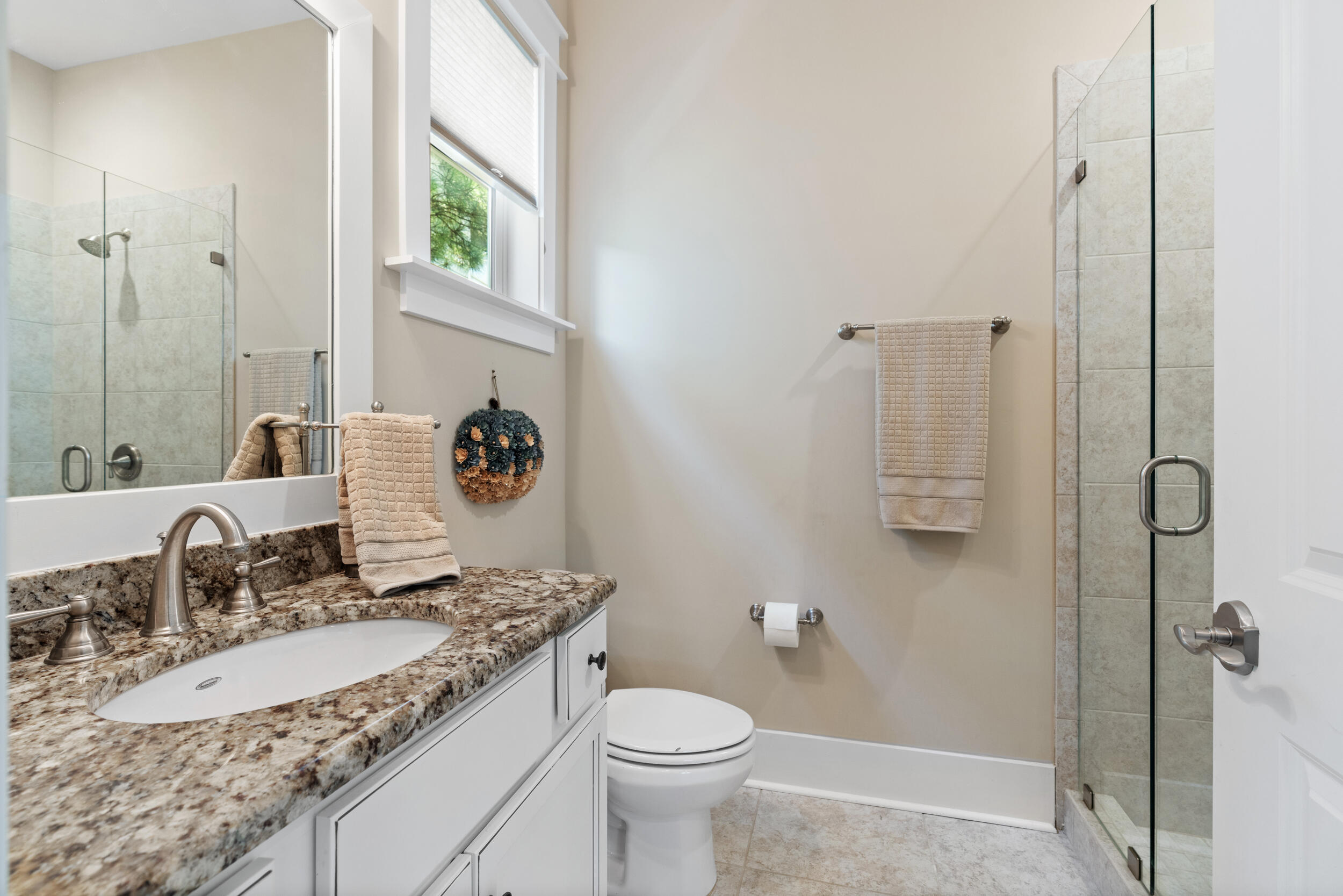 694 Flatwoods Forest Loop Santa Rosa Beach, FL 32459 - Photo 16 of 50 a bathroom with a granite countertop sink mirror vanity and toilet