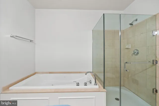 an empty room with windows and fireplace