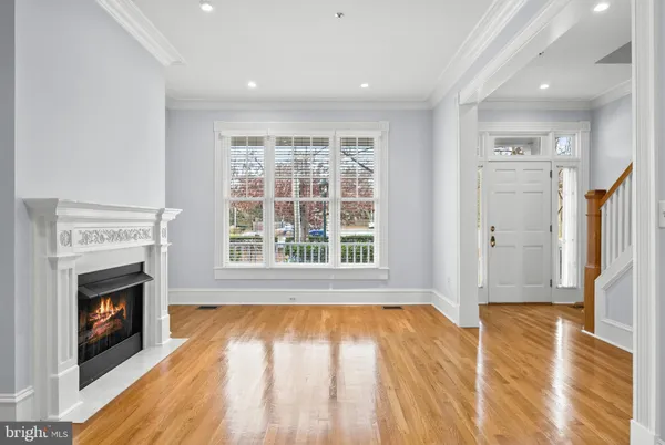 a view of empty room with wooden floor and fireplace