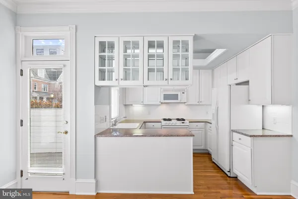 a kitchen with cabinets and stainless steel appliances