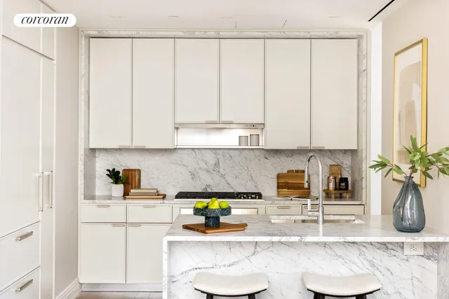 a living room with furniture kitchen view and large windows