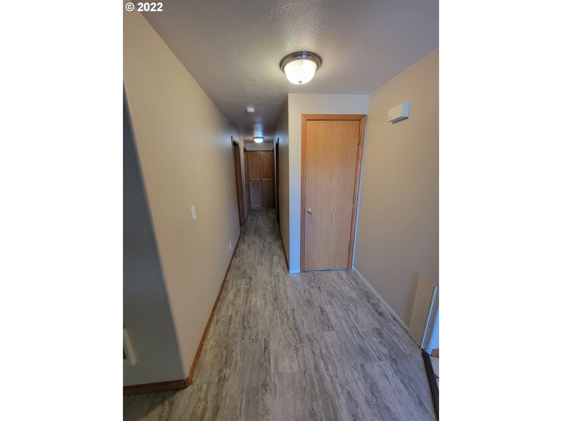 407 South 70th Place Springfield, OR 97478 - Photo 8 of 13 a view of hallway with wooden floor