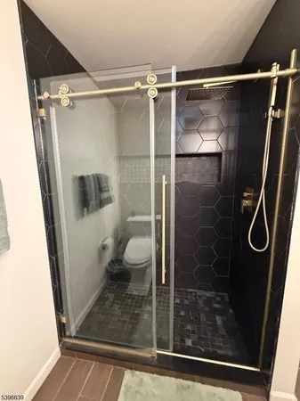 a bathroom with a glass shower door