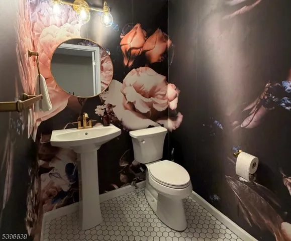 a bathroom with a sink toilet and mirror