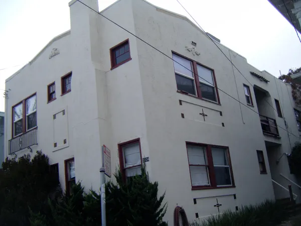 a front view of a house with plants