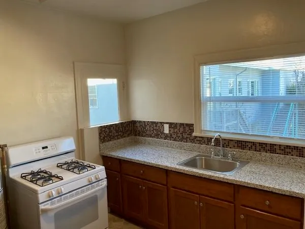 a kitchen that has a sink and a stove