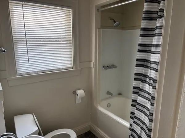 a bathroom with a bathtub and shower