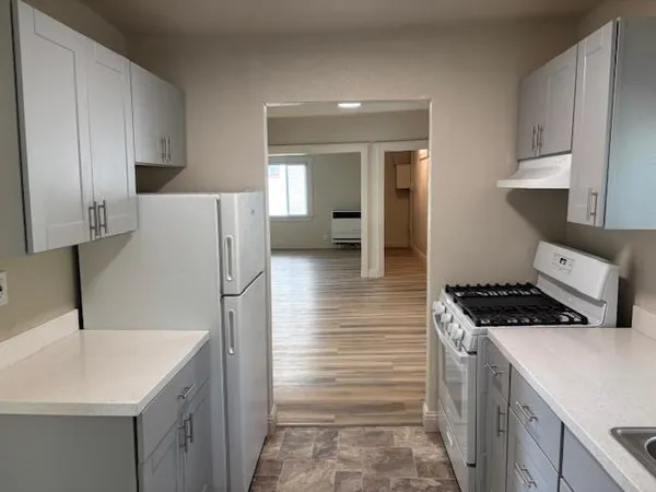 a kitchen with a sink cabinets and appliances