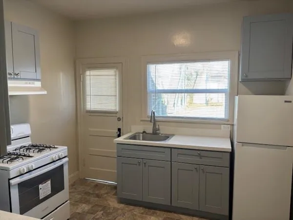 a kitchen with sink cabinets and a window