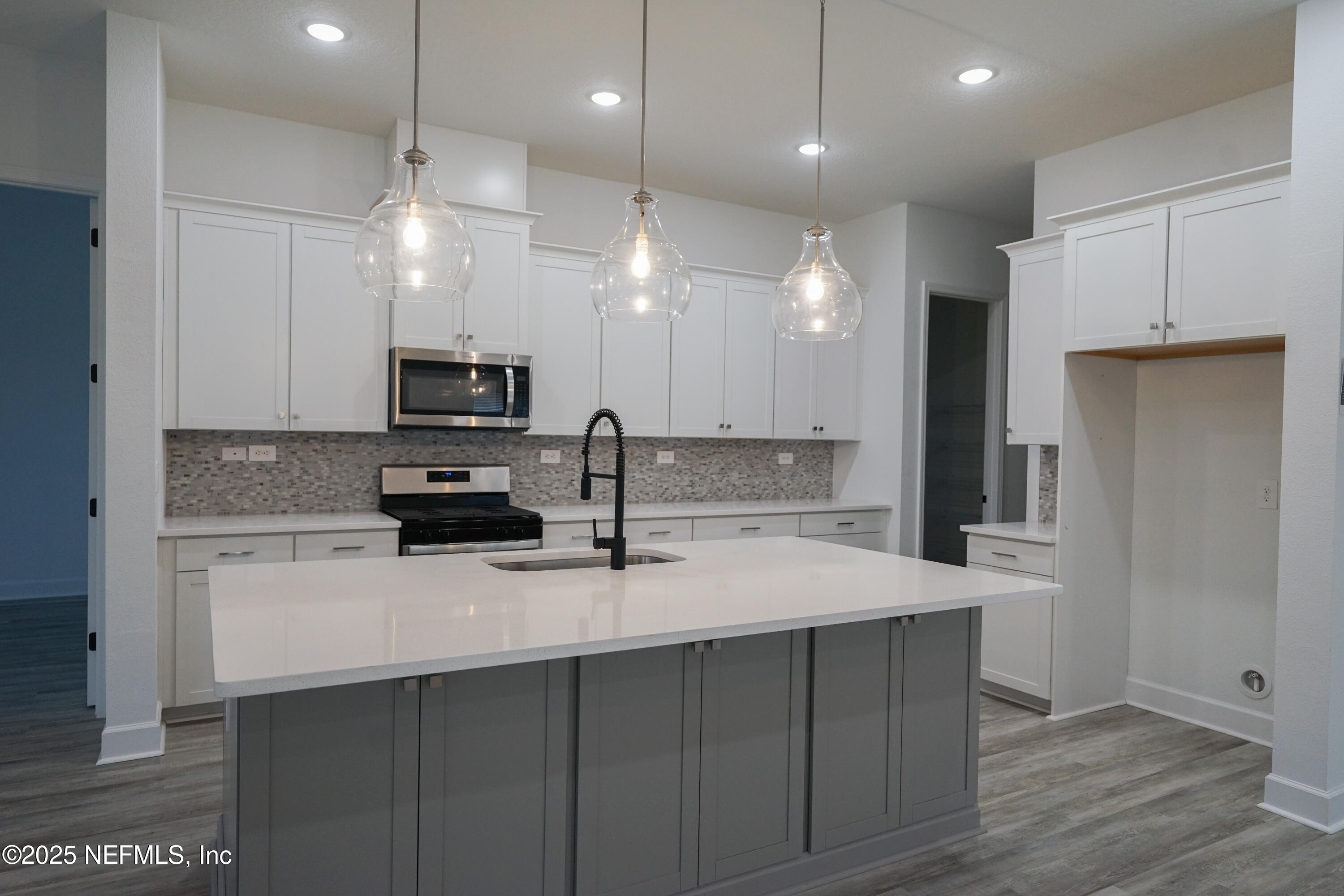 268 Blackbird Lane St. Augustine, FL 32092 - Photo 4 of 33 a kitchen with kitchen island a sink stainless steel appliances and cabinets