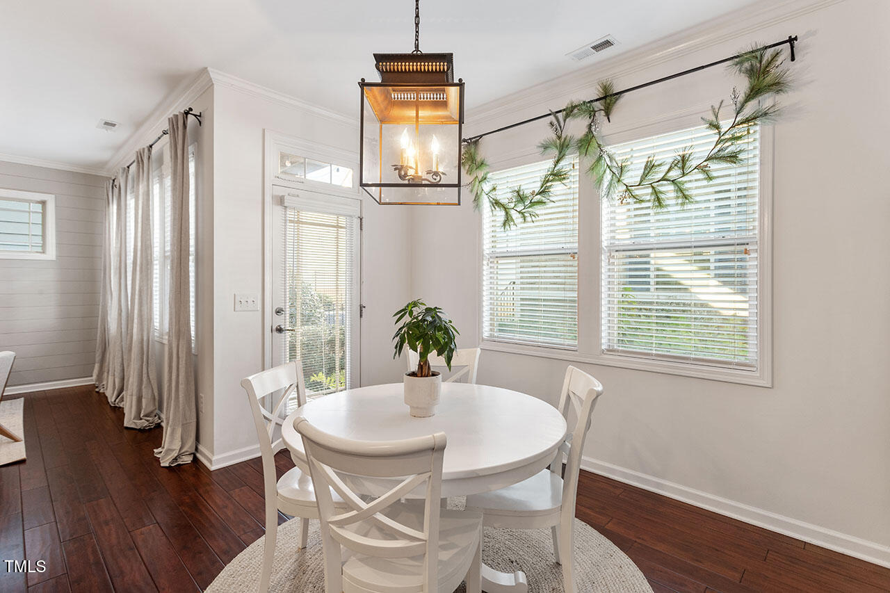 5614 Wade Park Boulevard Raleigh, NC 27607 - Photo 18 of 40 a view of a dining room with furniture window and wooden floor