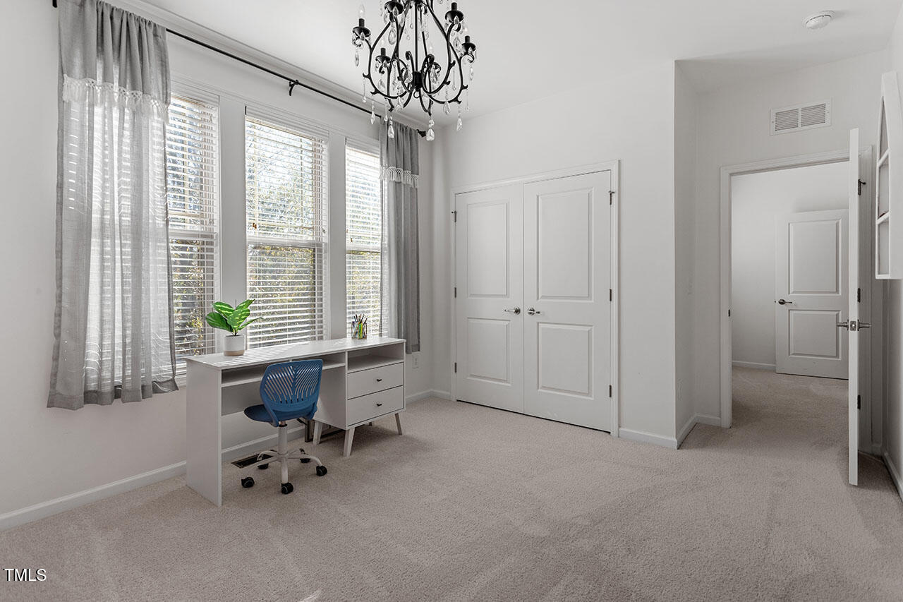 5614 Wade Park Boulevard Raleigh, NC 27607 - Photo 33 of 40 a view of an empty room with a window and a livingroom