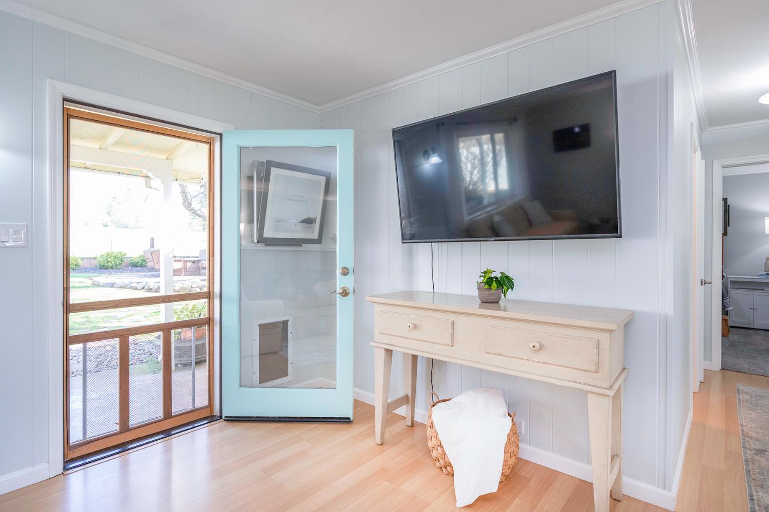 524 Williams Street Murphys, CA 95247 - Photo 26 of 64 a living room with a flat screen tv and a floor to ceiling window