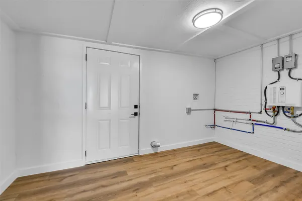 a view of a room with wooden floor