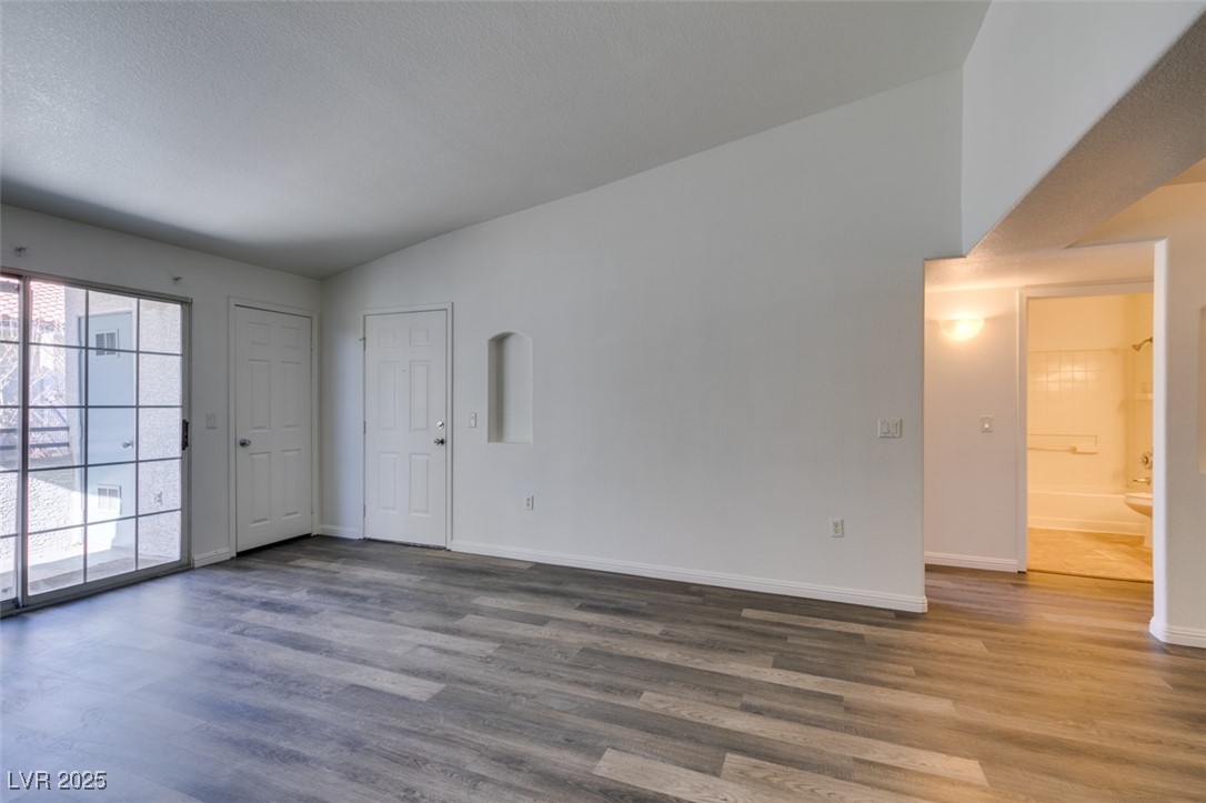 3318 North Decatur Boulevard, Unit 2138 Las Vegas, NV 89130 - Photo 12 of 40 Empty room featuring wood finished floors and baseboards