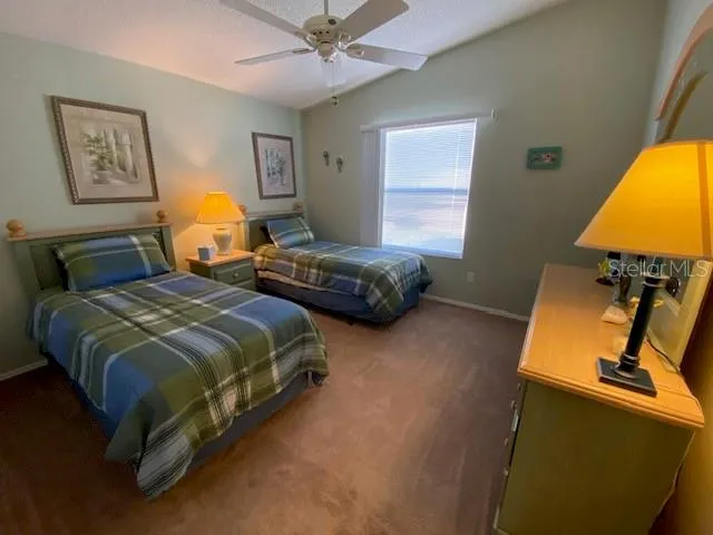 a bedroom with two beds and a lamp