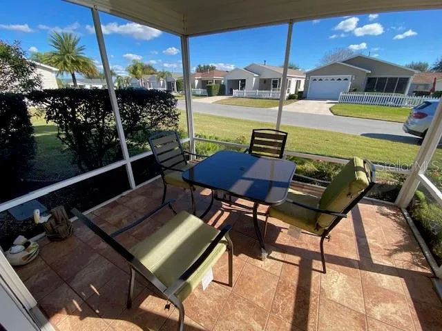 a view of a chairs and table in patio