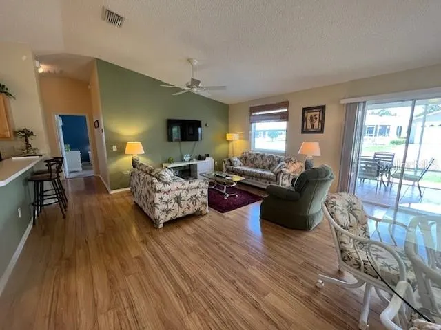 a living room with furniture window and wooden floor