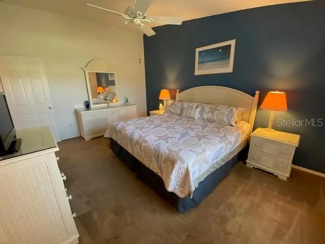 a bedroom with a bed and dresser with mirror