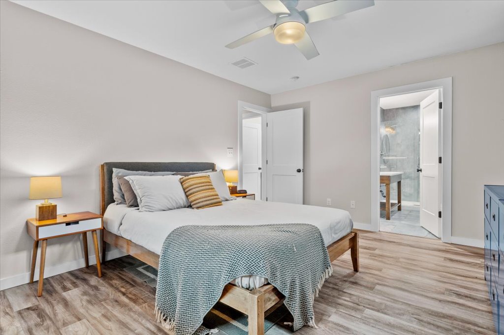 3010 Burleson Road, Unit A Austin, TX 78741 - Photo 16 of 28 Bedroom featuring light wood finished floors and ceiling fan