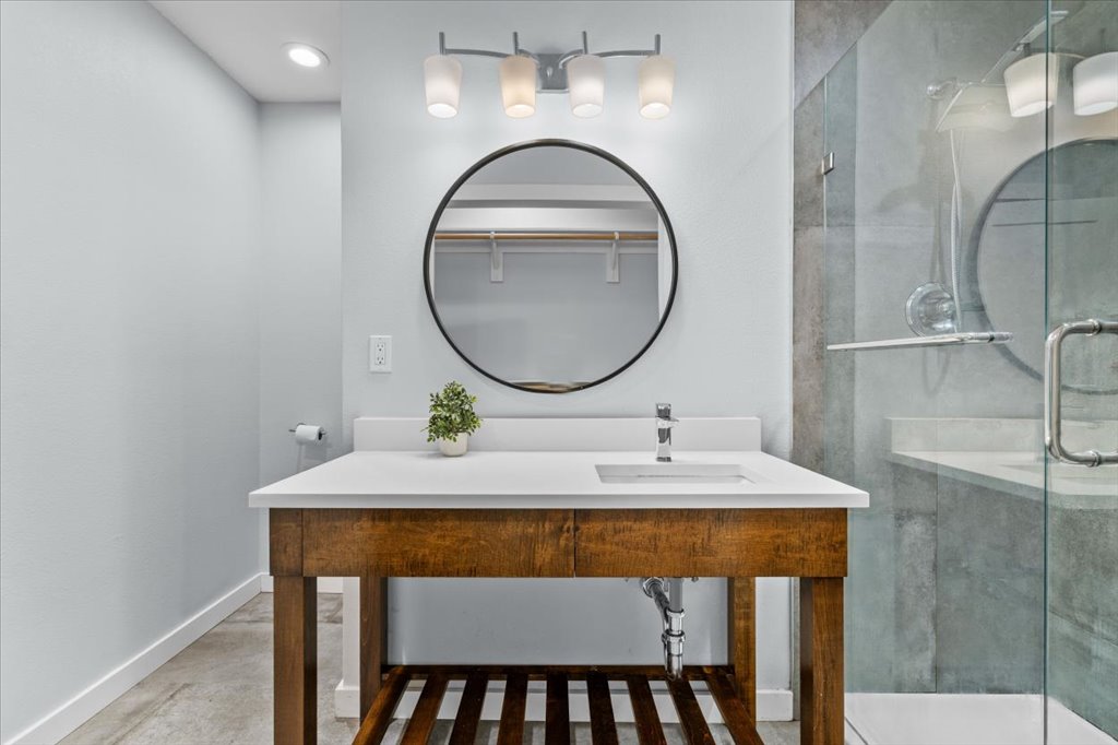 3010 Burleson Road, Unit A Austin, TX 78741 - Photo 18 of 28 Bathroom featuring a stall shower, vanity, and a walk in closet