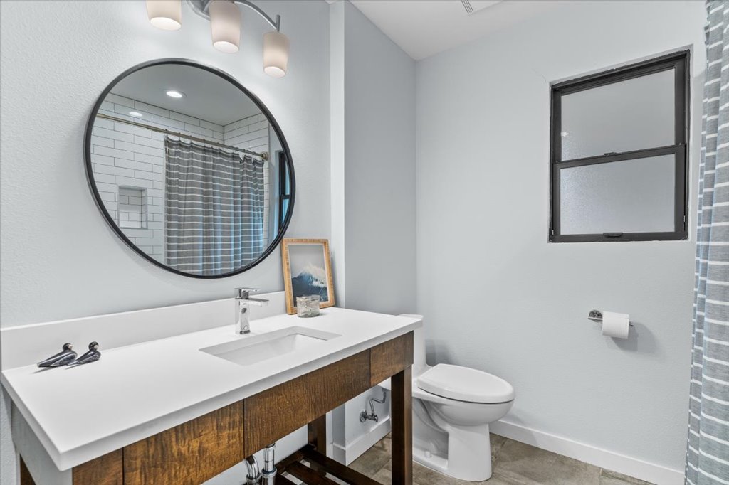 3010 Burleson Road, Unit A Austin, TX 78741 - Photo 20 of 28 Full bath with a shower with shower curtain and vanity