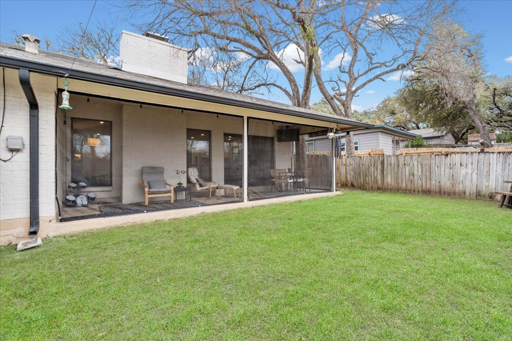 3010 Burleson Road, Unit A Austin, TX 78741 - Photo 23 of 28 Rear view of property featuring brick siding, a chimney, and a sunroom