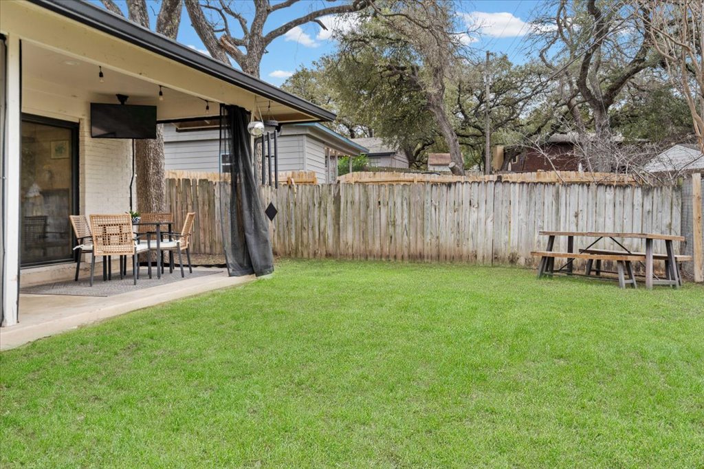 3010 Burleson Road, Unit A Austin, TX 78741 - Photo 25 of 28 Fenced backyard with outdoor dining area