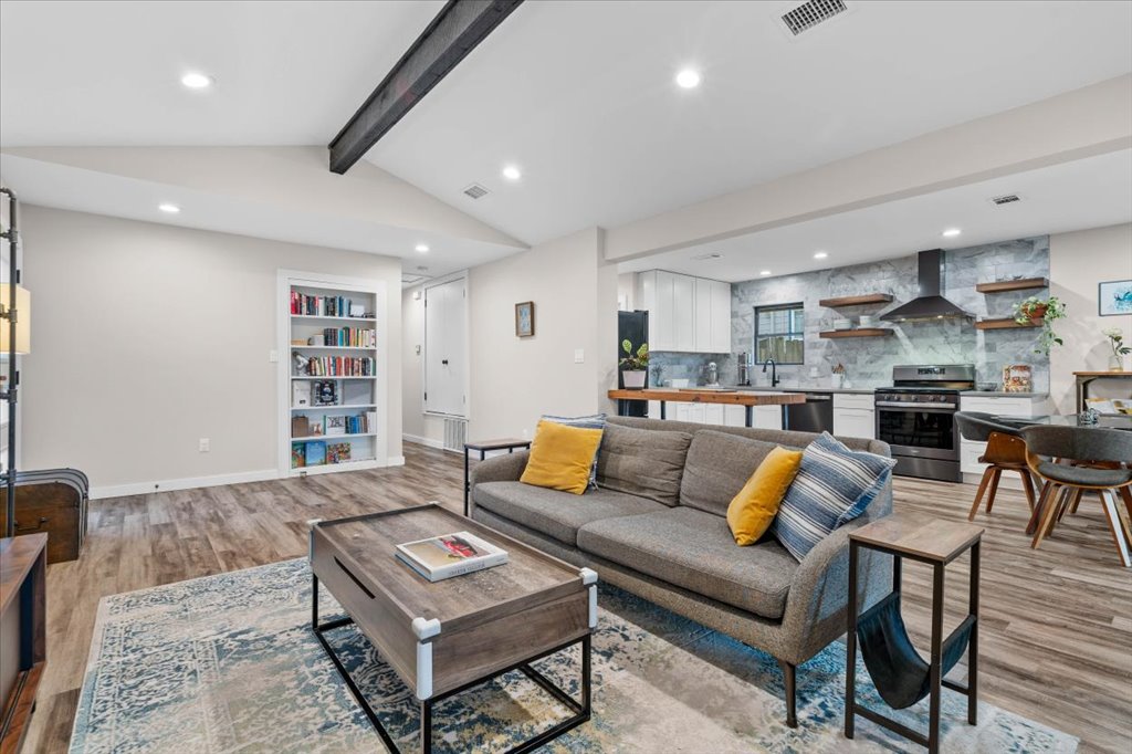 3010 Burleson Road, Unit A Austin, TX 78741 - Photo 5 of 28 Living room with beam ceiling, light wood finished floors, and recessed lighting