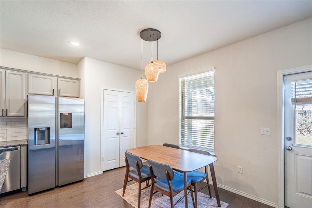 547 Saturnia Drive Georgetown, TX 78628 - Photo 16 of 39 a dining room with stainless steel appliances wooden floor and a refrigerator