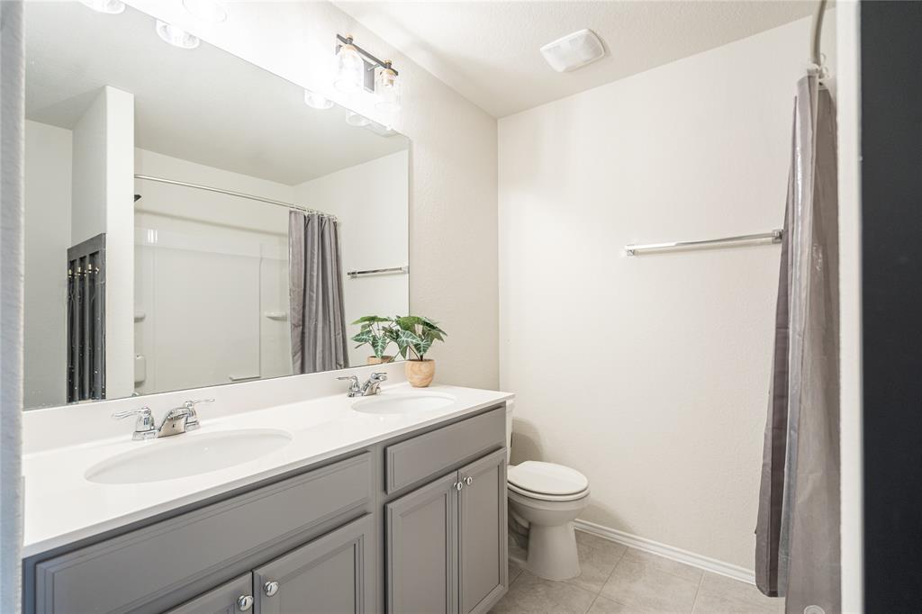 547 Saturnia Drive Georgetown, TX 78628 - Photo 27 of 39 a bathroom with a granite countertop sink toilet a large mirror and shower