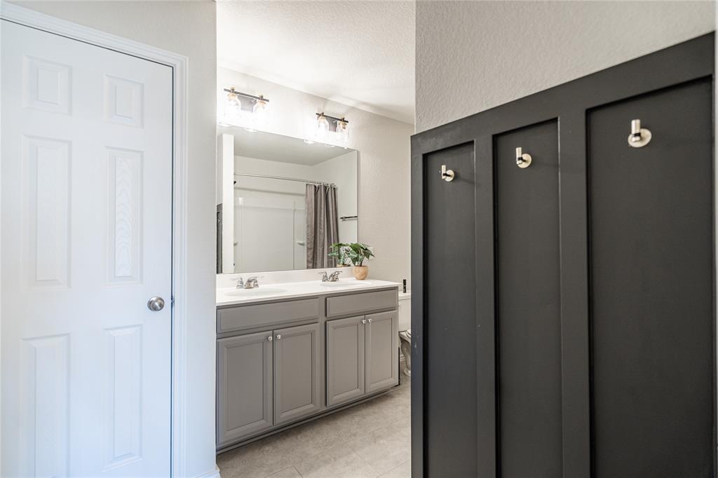 547 Saturnia Drive Georgetown, TX 78628 - Photo 30 of 39 a bathroom with a double vanity sink and mirror