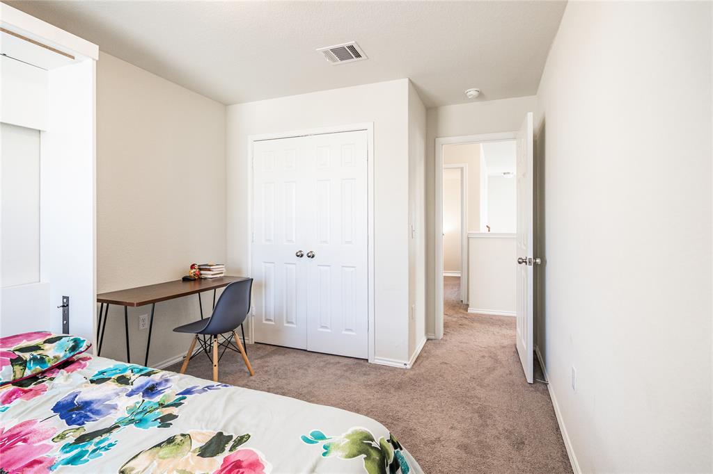 547 Saturnia Drive Georgetown, TX 78628 - Photo 32 of 39 a room that has a bed and a table in it